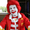 Rainbow Squared, Year 5, Piece Thirty-Five: 15. Yellow Red by James Defebaugh. An animated gif comprised of seven other animated gifs from the internet in a single loop. This includes a red-clad Ronald McDonald giving a double thumbs-down in yellow gloves, followed by an anthropomorphic computer-animated pizza slice with pepperoni breasts staring at the camera, followed by a plate of spaghetti being liberally sprinkled with mounds of parmesan cheese, followed by a jar of Gulden’s mustard puking out of a mouth-shaped hole in the top with googly eyes, followed by a hamburger/mustard/ketchup gun spitting out pickles, followed by Homer Simpson feeding a slice of pizza directly into his belly with a face drawn on it while Bart Simpson looks on, followed by Disney’s Cinderella going from rags to a melting ball gown made of cheese and pepperoni.