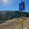 Rainbow Squared, Year 5, Piece Thirty-Six: 31. Blue Yellow. An animated photo loop of  California highway emergency call boxes, with a blue sign that says “CALL BOX” including specific coordinated sits on a pole atop a yellow box. We see several shots of cards passing by these signs and then a close up of a hand opening the box and looking inside to reveal the phone and a QWERTY keypad.